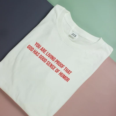 Áo thun oversize cotton mỏng in chữ GOD HAS GOOD SENSE OF HUMOUR [Clearance]